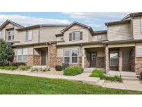 Charming townhouse exterior with stone accents and well-maintained landscaping on a sunny day at 17032 Blue Mist Grv, Monument, CO 80132
