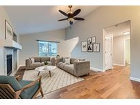 Spacious living room featuring hardwood floors, fireplace, and neutral color palette at 303 Tumbleweed Dr, Brighton, CO 80601