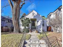 Charming stucco home with a green door and mature landscaping at 2339 S Adams St, Denver, CO 80210