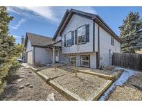Charming two-story home with neutral siding, dark trim, and a well-manicured front yard at 17652 E Temple Dr, Aurora, CO 80015