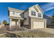 Charming two-story home boasts a lovely exterior with a well-manicured lawn and attached two car garage at 254 Ellendale St, Castle Rock, CO 80104