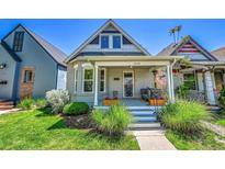 Charming home featuring a covered front porch and well-maintained lawn at 1208 S Pennsylvania St, Denver, CO 80210