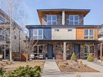 Modern townhome with stone and wood accents, featuring a well-manicured front yard and inviting entryway at 4529 Vrain St, Denver, CO 80212