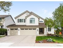 Charming two-story home with three-car garage and well-manicured lawn at 9574 Las Colinas Dr, Lone Tree, CO 80124