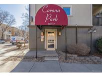 Welcoming building entrance with a red awning displaying 