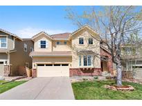 Charming two-story home with a well-manicured lawn and a welcoming front entrance at 10633 Wynspire Way, Highlands Ranch, CO 80130