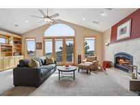 Bright living room with vaulted ceilings, fireplace, built-ins, and scenic mountain views at 156 S Lookout Mountain Rd, Golden, CO 80401