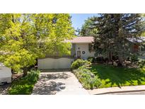 Charming home with a well-manicured lawn, mature trees, and a two-car garage, perfect for suburban living at 1560 Findlay Way, Boulder, CO 80305