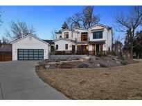 Striking modern farmhouse with large windows, black trim, and three-car garage on a professionally landscaped lot at 815 E Westglow Ln, Greenwood Village, CO 80121