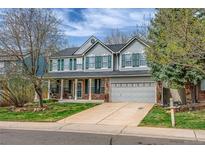 Charming two-story home with a well-maintained front yard, green shutters and a two car garage at 2225 Clayton Cir, Superior, CO 80027
