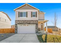 Charming two-story home with stone accents and a two-car garage, presenting a welcoming curb appeal at 18029 Dandy Brush Ln, Parker, CO 80134