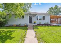 Charming single-story home with manicured lawn and inviting walkway leading to the front door at 1888 S Filbert Ct, Denver, CO 80222