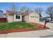 Charming single-story home featuring a well-maintained yard, solar panels, and a two-car garage at 646 S Joplin St, Aurora, CO 80017