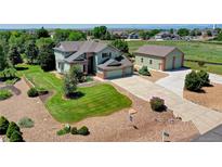 Expansive lawn and well-manicured landscaping create great curb appeal for this home at 8720 E 163Rd Pl, Brighton, CO 80602