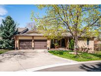 Charming home with a well-manicured lawn, mature tree, and a convenient two-car attached garage at 2615 Oak Dr # 7, Lakewood, CO 80215