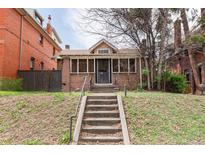 Charming brick home with a welcoming front porch and steps leading to the entrance at 1445 Saint Paul St, Denver, CO 80206