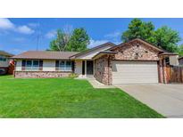 Charming single Gathering home features stone accents and a well-maintained lawn at 633 S Galena St, Denver, CO 80247