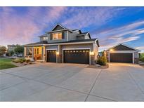 Beautiful two-story home with a three-car garage and a separate one-car garage and a large driveway at 5181 Appleton Way, Castle Rock, CO 80104