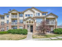 Attractive townhome with brick accents, balconies, and well-maintained landscaping at 5714 N Gibralter Way # 5-204, Aurora, CO 80019