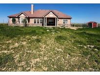 Charming single-story home featuring a classic design and well-manicured front lawn at 13291 N Harback Rd, Bennett, CO 80102