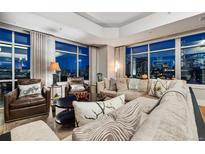 Elegant living room featuring plush seating and expansive windows with city views at 1411 Wynkoop St # 806, Denver, CO 80202