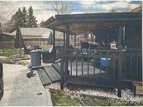 Cozy backyard covered patio with black wood features and gravel at 110 S Hoyt St, Lakewood, CO 80226
