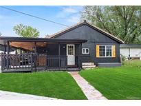 Charming, renovated home with a manicured lawn and covered deck for outdoor relaxation at 110 S Hoyt St, Lakewood, CO 80226