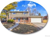 Charming two-story home features a well-maintained lawn and a two-car garage at 6720 S Adams Way, Centennial, CO 80122