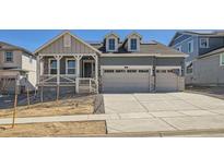 Charming two-story home with a two car garage, landscaped front yard, and covered front porch at 631 Sunrise St, Erie, CO 80516