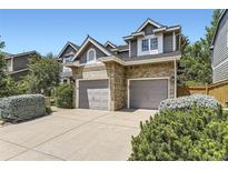 Home featuring a two-car garage and beautiful brick and siding exterior at 16257 E Belleview Pl, Centennial, CO 80015