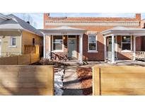 Charming brick duplex with updated porches and modern wood fencing at 2929 N Josephine St, Denver, CO 80205