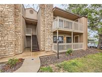 Charming multi-story condo building with stone accents, wood trim, and inviting outdoor balconies at 10293 E Peakview Ave # F104, Englewood, CO 80111