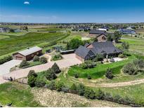 Expansive property featuring well-manicured landscaping, detached garage, and serene acreage views at 34827 E 7Th Ave, Watkins, CO 80137