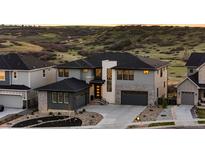 Beautifully landscaped two-story home boasts modern architecture and mountain views at 7611 Copper Sky Ct, Castle Pines, CO 80108