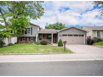 Charming two-story home with a well-manicured lawn, mature trees, and a two-car garage at 1962 S Ivory Way, Aurora, CO 80013
