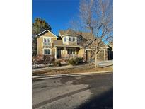 Two-story house with a large front porch and attached two-car garage at 6297 W Prentice Ave, Littleton, CO 80123