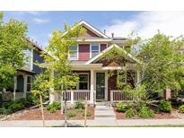 Charming two-story home with a well-maintained front yard and inviting front porch at 3415 Florence Way, Denver, CO 80238