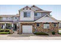 Charming townhome featuring stone accents, a one car garage and inviting curb appeal at 14000 Winding River Ct # T3, Broomfield, CO 80023