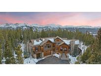 Stunning mountain home with snow-capped peaks, log accents, and a picturesque wooded setting at 378 Juniata Cir, Breckenridge, CO 80424