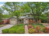 Charming two-story home with a brick pathway, lush landscaping, and mature trees at 40 S 34Th St, Boulder, CO 80305