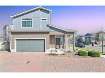 Inviting two-story home with a two car garage, brick driveway, and well-maintained landscaping at 20017 E 48Th Pl, Denver, CO 80249