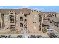 Beautiful condo building with stone accents, private balconies, and well-maintained landscaping at 17297 Wilde Ave # 205, Parker, CO 80134