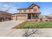 Charming two-story home with a three-car garage and inviting front porch at 7251 S Old Hammer Way, Aurora, CO 80016