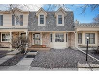 Charming townhome featuring a well maintained front exterior with a stone front yard at 7580 S Cove Cir, Centennial, CO 80122