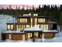 Modern, multi-story home with balconies, and mountain views surrounded by snow at 310 N Fuller Placer Rd, Breckenridge, CO 80424