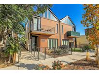 Contemporary townhome exterior with brick facade, balconies, modern railing and professional landscaping at 4232 Jason St # 7, Denver, CO 80211