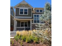 Charming two-story home featuring a cozy front porch and well-manicured landscaping at 13788 Umatilla Ln, Broomfield, CO 80023