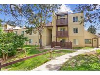 Inviting exterior of a multi-level home with private balconies and lush landscaping at 9995 E Harvard Ave # 290, Denver, CO 80231