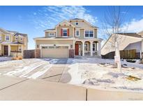 Two-story house with attached garage and snowy front yard at 7242 E 133Rd Cir, Thornton, CO 80602