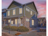 Charming two-story home with stone accents and a landscaped yard at sunset at 13624 Garfield St # G, Thornton, CO 80602